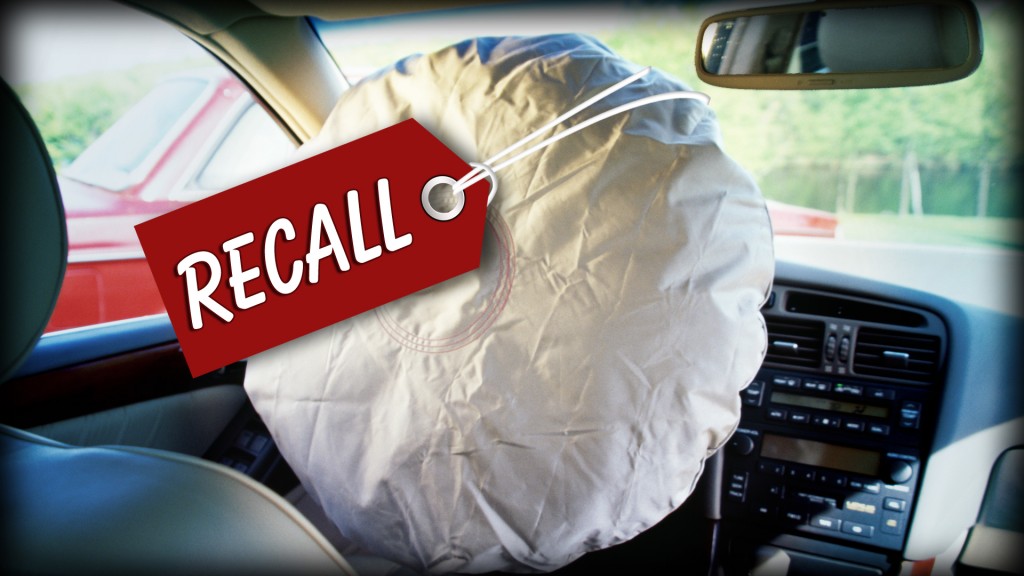 Defective airbag with recall tag inside a car