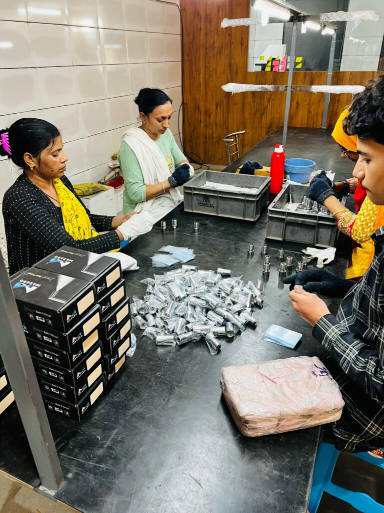 Indian Female and Male Labour inspecting product for packing.